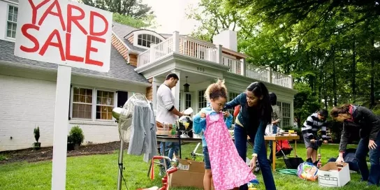 Sell Your Unwanted Items at a Garage Sale with Young Girl Trying on Dress